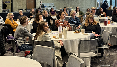 women listen to guest speaker during fall breakfast